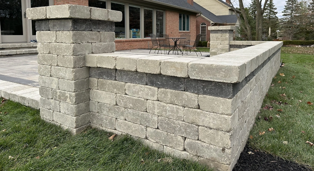 Blackstone Landscaping installing a segmental retaining wall along a Northville Michigan driveway